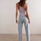 back view of model wearing light denim with cute stitching on the front and inner legs