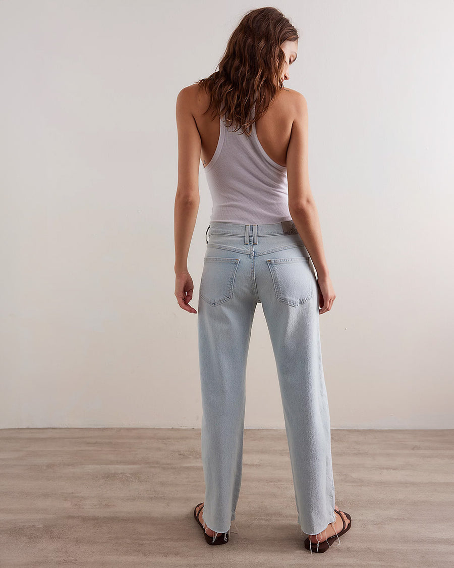 back view of model wearing light denim with cute stitching on the front and inner legs