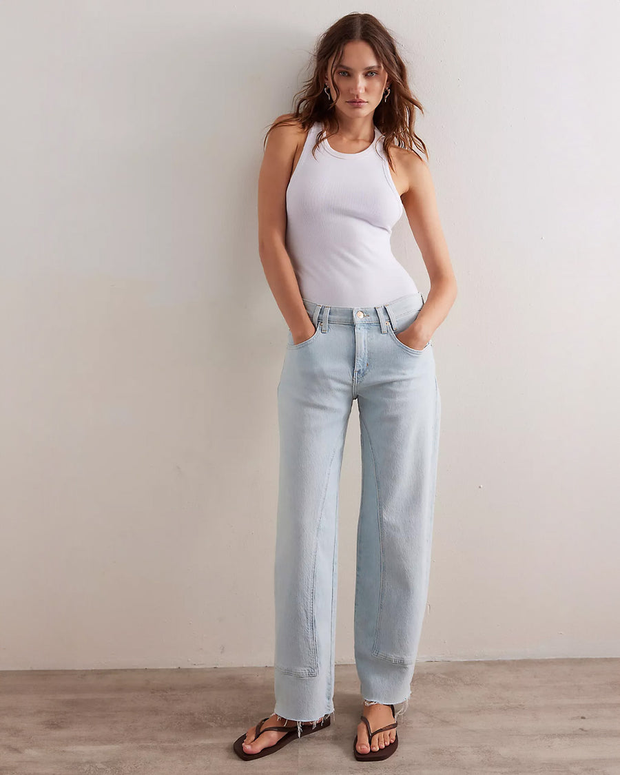 model wearing light denim with cute stitching on the front and inner legs