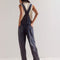 back view of model wearing washed black relaxed fit overalls