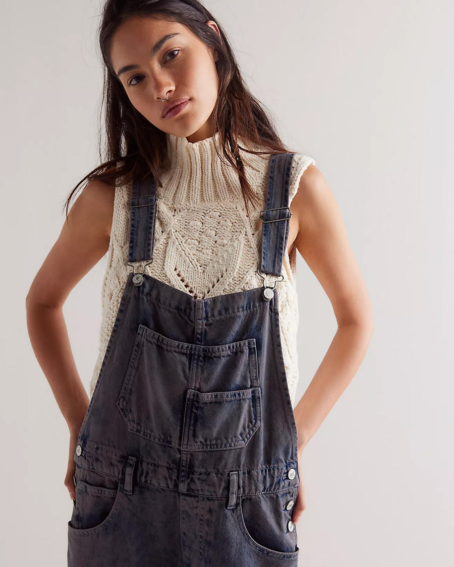 up close of model wearing washed black relaxed fit overalls