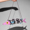 silver chain strap on black and white beaded fish shaped clutch bag with pink face and blue fins