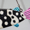 up close of beading on black and white beaded fish shaped clutch bag with pink face and blue fins