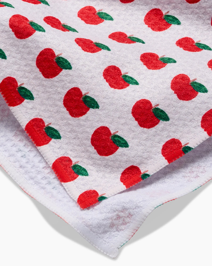 up close of pink tea towel with all over apple print