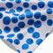 up close of white bar tea towel with all over blueberry print