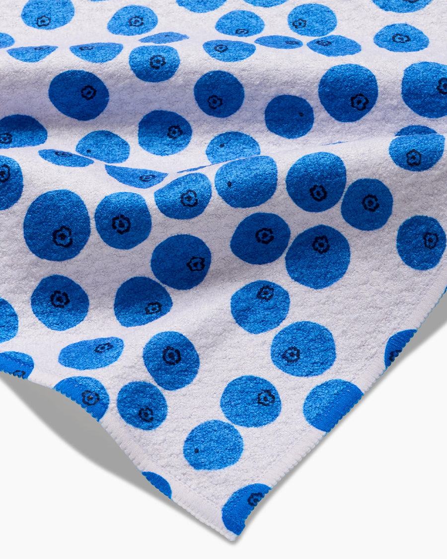 up close of white bar tea towel with all over blueberry print