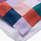 up close of teal, purple, orange, and white checkered tea towel