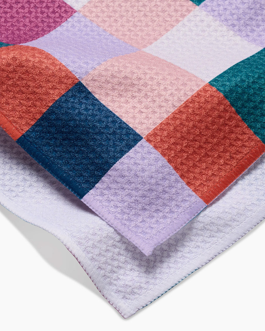 up close of teal, purple, orange, and white checkered tea towel