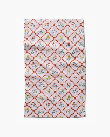 light pink cottagecore tea towel with delicate floral and criss cross pattern