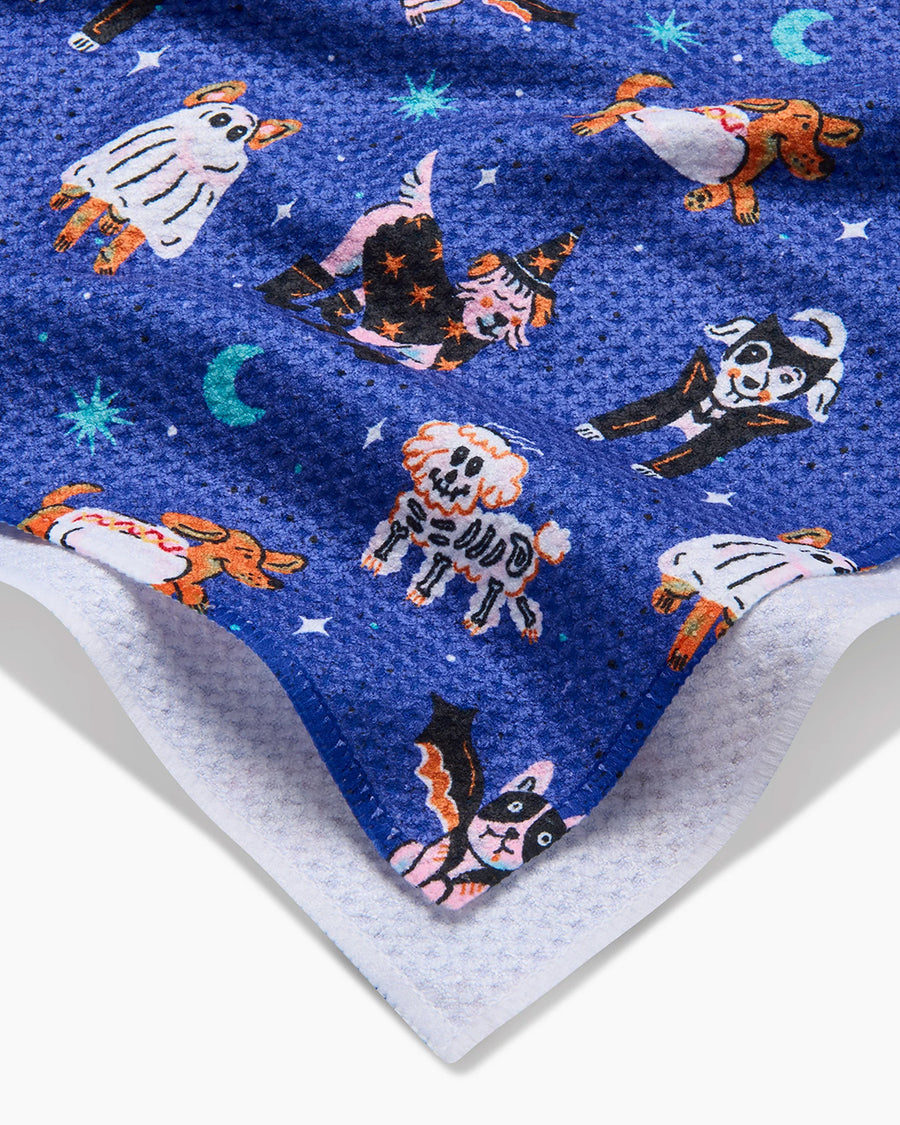 up close of blue tea towel with dogs in costumes print