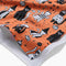 up close of orange tea towel with cats in costumes print