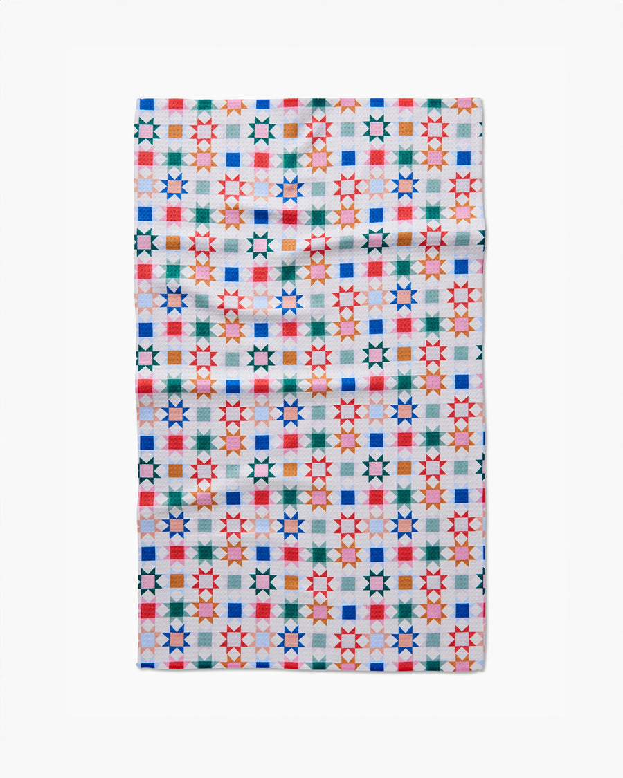 white tea towel with colorful patchwork print