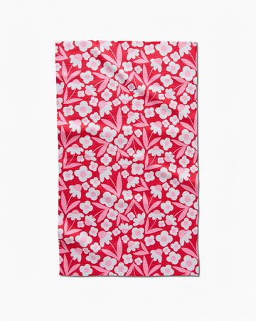 red tea towel with white flowers and pink accents