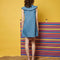 back view of model wearing sleeveless denim stripe mini dress with zipper front and oversized collar