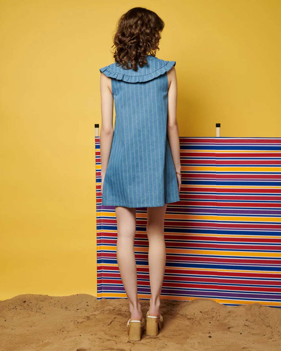 back view of model wearing sleeveless denim stripe mini dress with zipper front and oversized collar