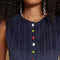 up close of model wearing blue corduroy mini dress with colorful button front