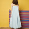 back view of model wearing light blue midi dress with spaghetti straps and bubble hem