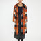 model wearing orange, black and grey checkered textured midi coat