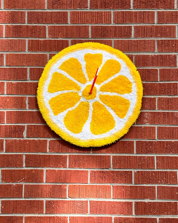 tufted lemon clock with red hands