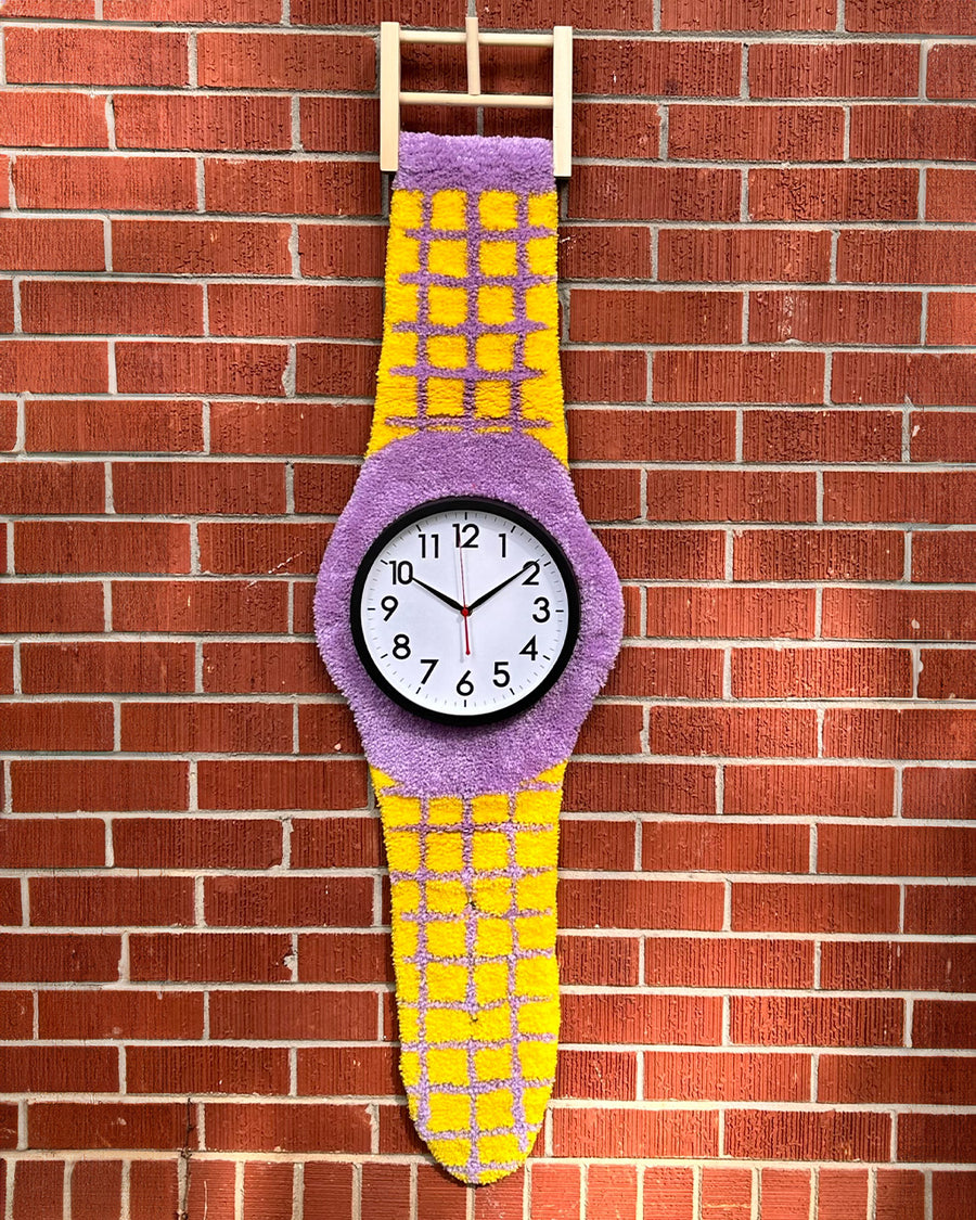 yellow and purple tufted watch shaped clock