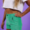 model wearing green corduroy shorts