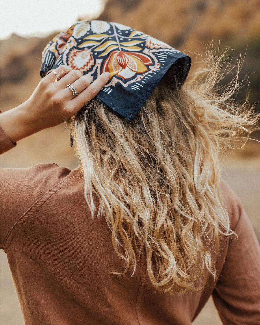 model wearing navy square bandana with yellow and mauve boho floral print