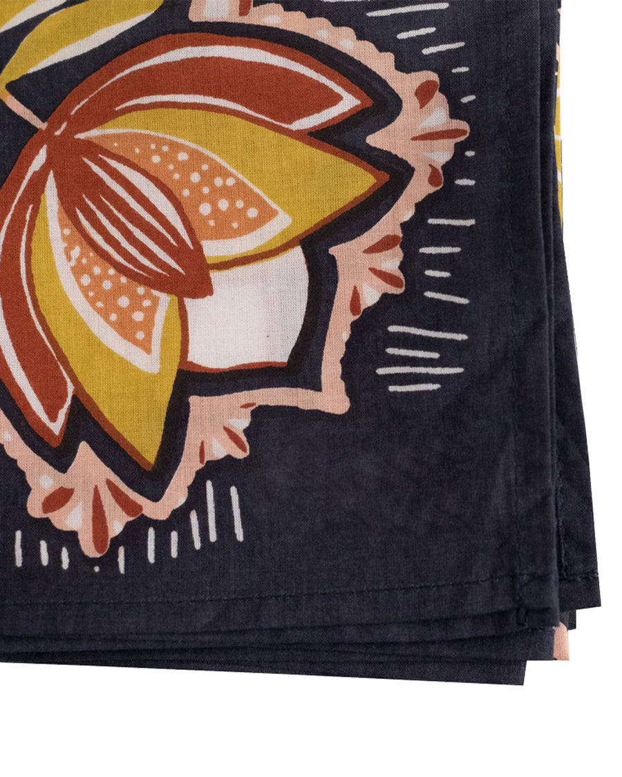 up close of navy square bandana with yellow and mauve boho floral print