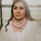 model wearing pink square bandana with galloping horse print