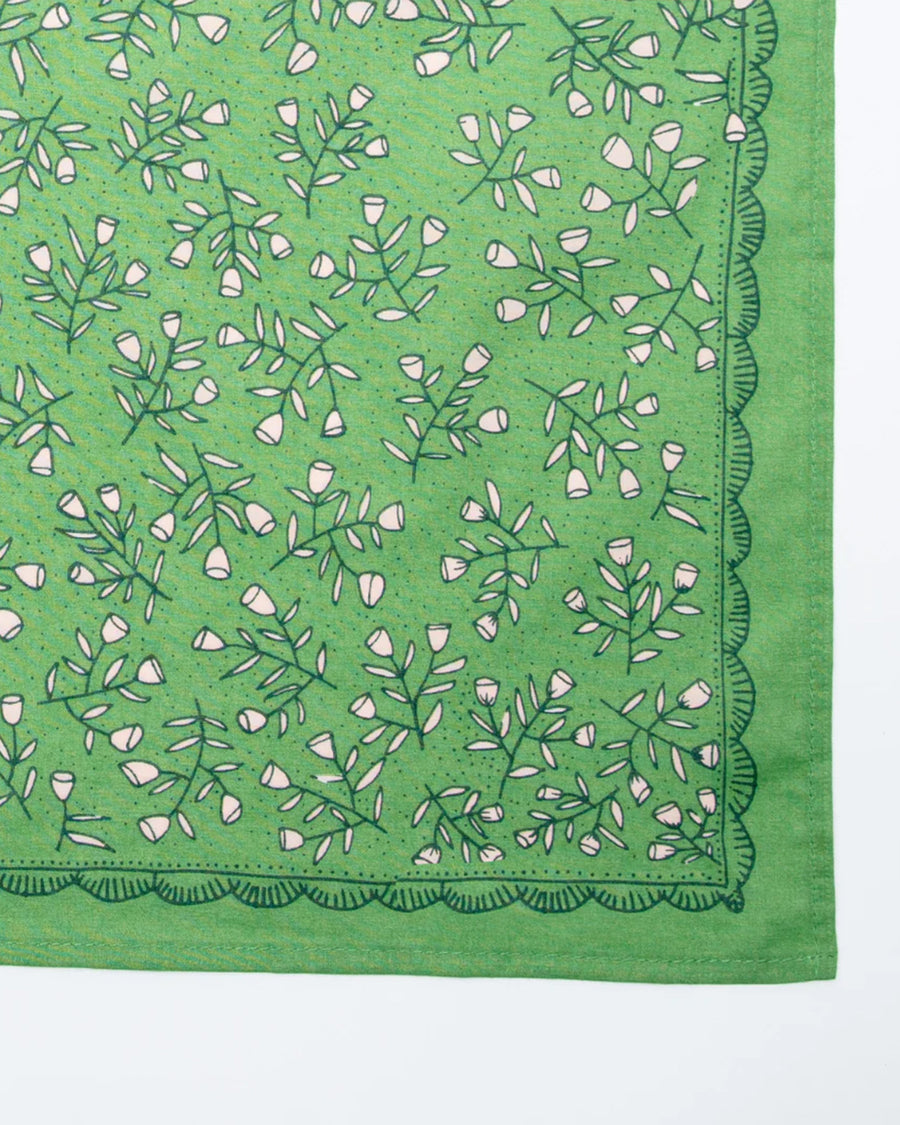 up close of kelly green square bandana with dainty white floral print