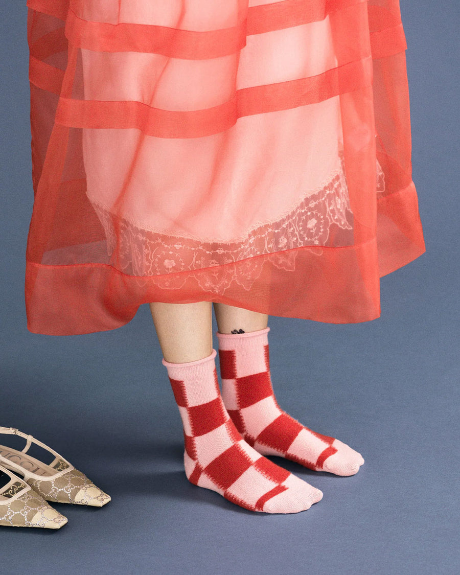 model wearing large pink and red checkered high socks