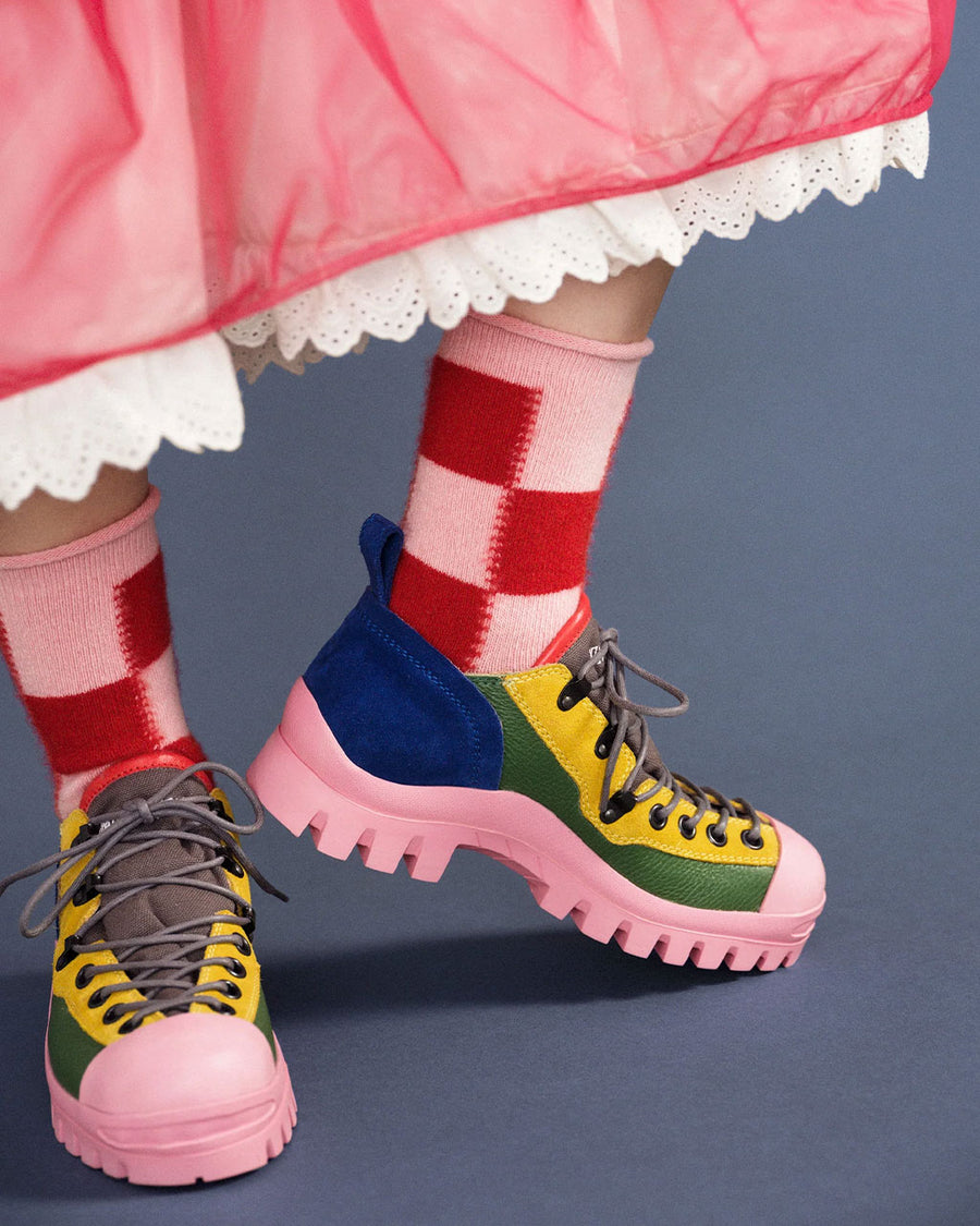 up close of model wearing large pink and red checkered high socks