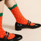 model wearing red strawberry socks with yellow dots and green scalloped top hem