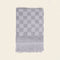 folded grey checkered bath towel