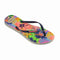 side view of pair of colorful neon floral print flip flops with navy thin straps
