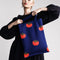 model holding blue tote bag with all over tomato print