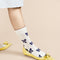 up close of model wearing white crew socks with blue bow print