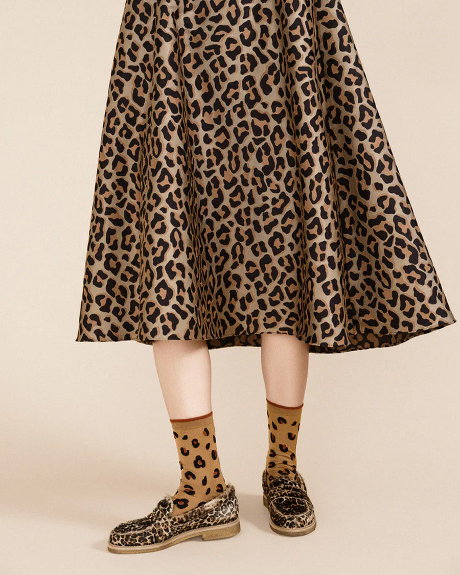 model wearing light brown crew socks with black and brown leopard print