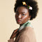 model wearing white and yellow flower cotton hair clips in their hair