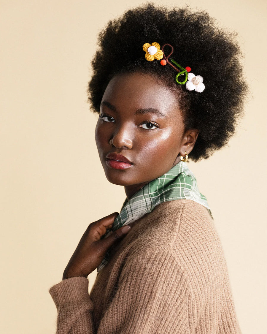 model wearing white and yellow flower cotton hair clips in their hair