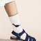 model wearing white crew socks with blue dino print