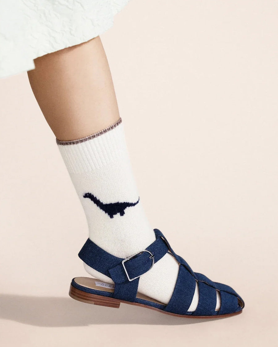 model wearing white crew socks with blue dino print