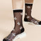 up close of model wearing black sheer socks with white trim and dainty white flowers