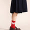 model wearing red socks with pink heart