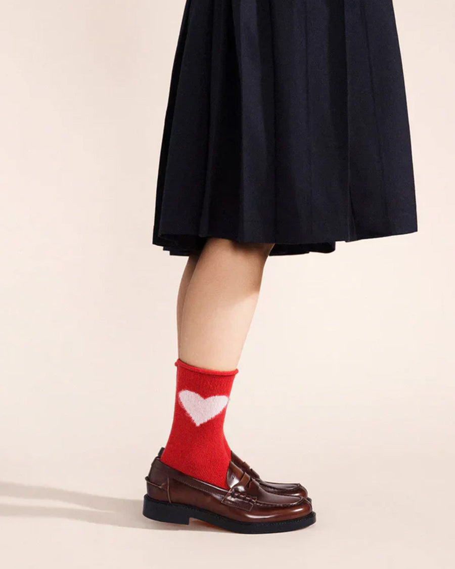 model wearing red socks with pink heart