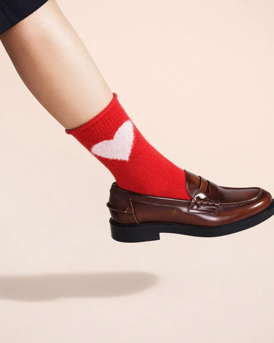 up close of model wearing red socks with pink heart