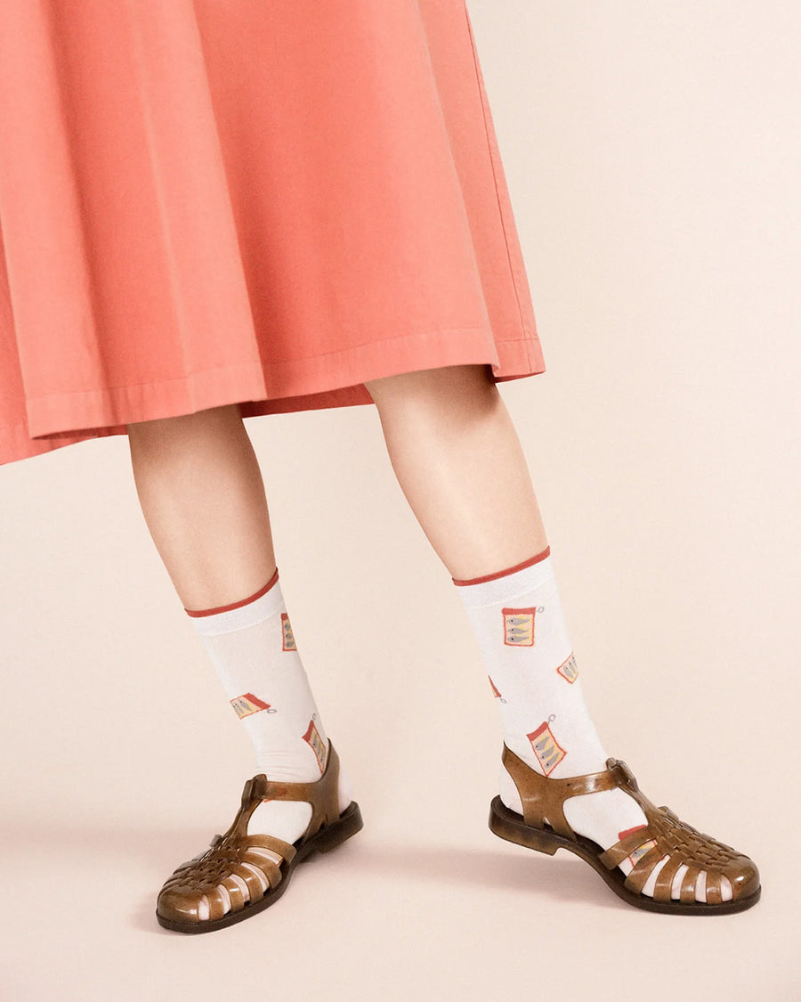 model wearing white crew socks with canned sardine print