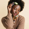 model wearing set of 2 hair clips: white strawberries with green border and brown veggies with white border