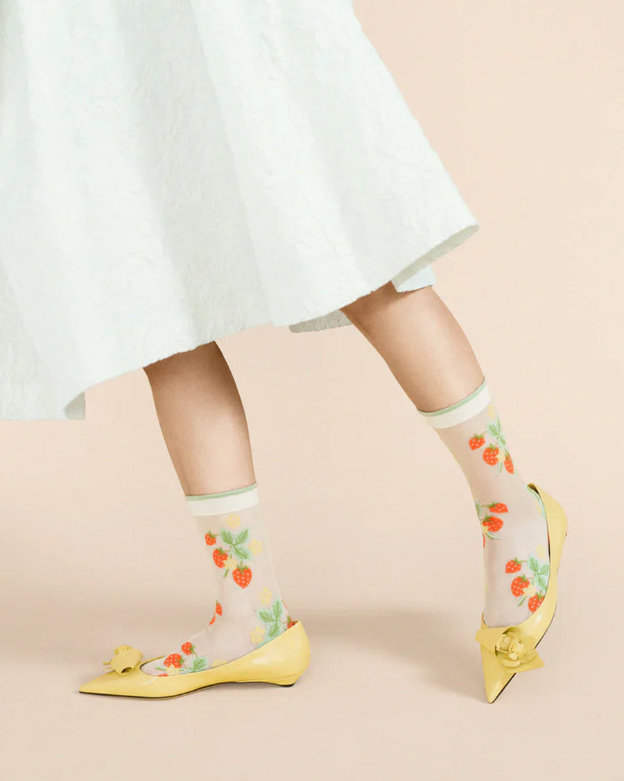 side view of white sheer socks with all over wild strawberry print