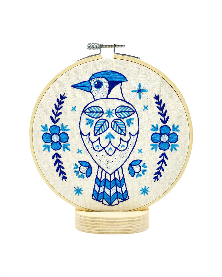 blue folk blue jay embroidery kit on a stand