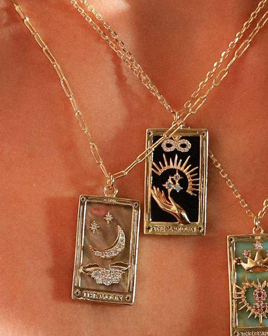 model wearing the magician gold tarot card necklace